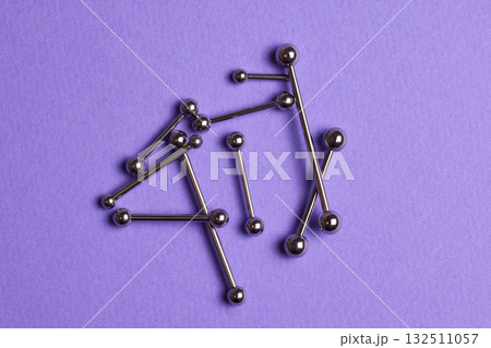 Piercing earrings close-up. On a Violet background. 132511057