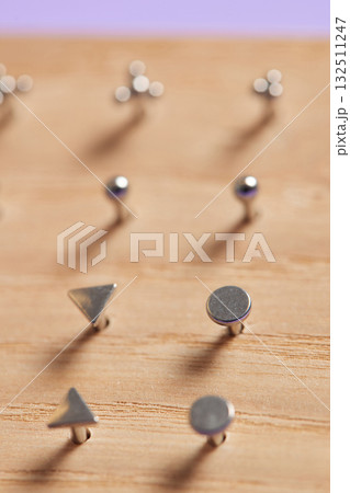 Beautiful piercing jewelry on wooden display. Macro shot. Selective focus. Beautiful piercing jewelry on wooden display. Macro shot. Selective focus. 132511247