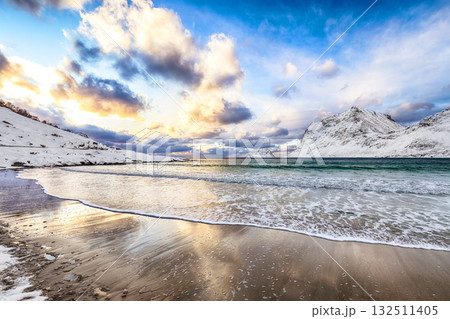 Amazing winter view of Vik beach during sunset with lots of snow  and snowy  mountain peaks near Leknes. 132511405