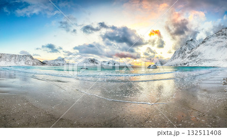 Stunning winter scenery with Haukland beach during sunset and snowy  mountain peaks near Leknes. 132511408