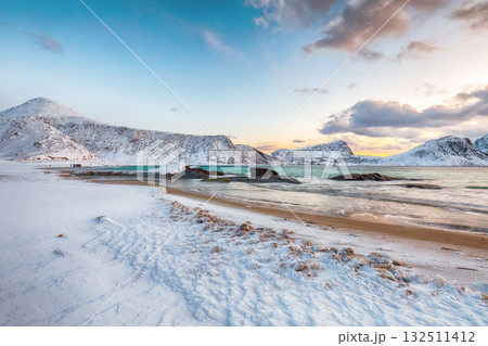 Unbeliveble winter view of Vik beach during sunset with lots of snow  and snowy  mountain peaks near Leknes. 132511412