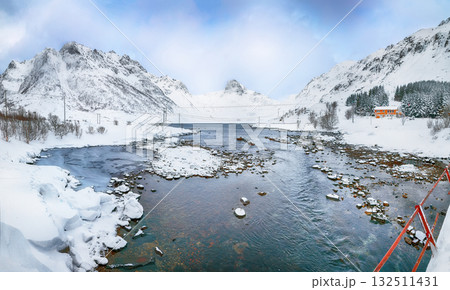 Dramatic winter scene of Kartfjorden on Vestvagoy island with snowy mountain peaks on Lofoten Islands . Dramatic winter scene of Kartfjorden on Vestvagoy island with snowy mountain peaks on Lofoten Islands . 132511431