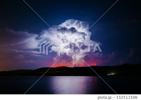 An ominous storm clouds are highlighted by lightning. An ominous storm clouds are highlighted by lightning. 132511506