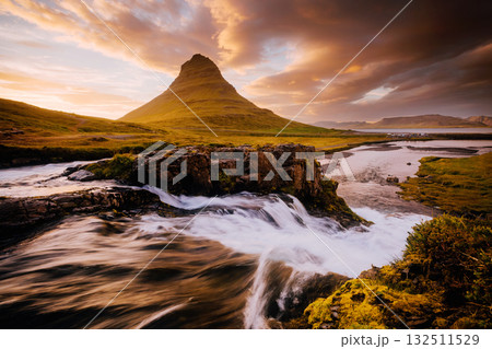 An epic sunset with Kirkjufellsfoss waterfall. Location Iceland, Europe. 132511529