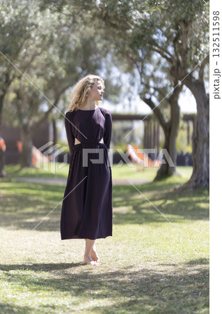 Young woman enjoying warm summer day outdoors 132511598