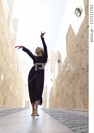 Woman dancing barefoot expressing freedom and spiritual uplifting 132511762
