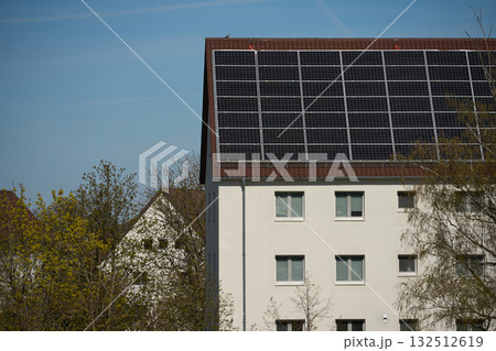 Residential building with solar panels on roof. Residential building with solar panels on roof. 132512619