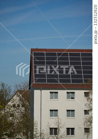 Residential building with solar panels on roof. Residential building with solar panels on roof. 132512620
