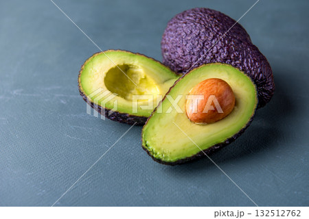 Dark, ripe avocados on a rustic green surface. Dark, ripe avocados on a rustic green surface. 132512762