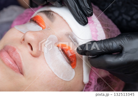 Caucasian woman undergoing eyelash lamination procedure.  132513345