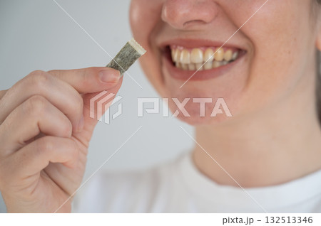 Woman Chewing Nicotine Snus Product. Woman Chewing Nicotine Snus Product. 132513346