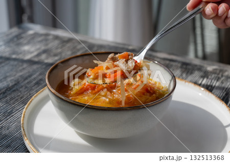 A bowl of shchi soup in a cafe.  132513368