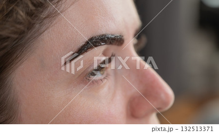 Caucasian woman getting eyebrow tinting procedure.  132513371