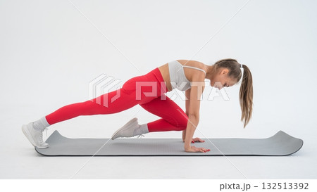 Young woman doing plank exercise on white background. 132513392