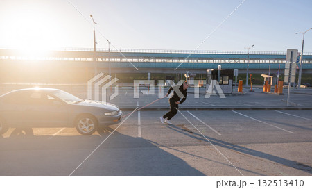 Caucasian man pulling a car with a rope. Caucasian man pulling a car with a rope. 132513410