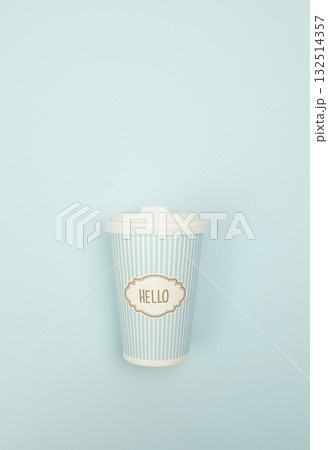 Flat lay image of a takeaway paper coffee cup on a blue backdrop, styled for business and product display purposes Flat lay image of a takeaway paper coffee cup on a blue backdrop, styled for business and product display purposes 132514357