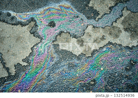Oil or gasoline slick producing vibrant rainbow patterns on the wet asphalt surface Oil or gasoline slick producing vibrant rainbow patterns on the wet asphalt surface 132514936