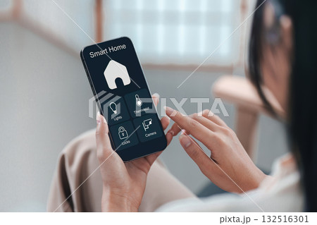 Smart Home Technology. User controlling home devices with smartphone app. 132516301