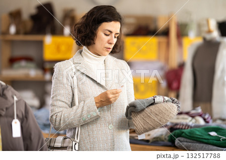 Woman choosing a knitted hat 132517788