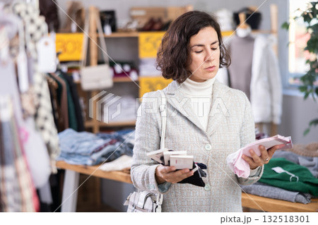 Adult woman choosing sets of socks in the store 132518301