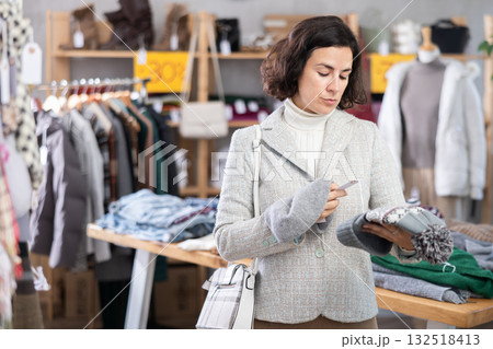 Woman choosing a knitted hat 132518413