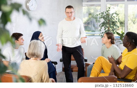 Male teacher lecturing at university with multinational students 132518660