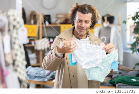 man chooses panties in a clothing store for his wife man chooses panties in a clothing store for his wife 132518735