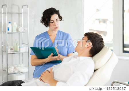 male patient documents signing 132518987