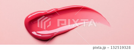 Pink lip gloss smear on a pink background creates a visually appealing textural contrast, perfect for beauty and cosmetic product advertising Pink lip gloss smear on a pink background creates a visually appealing textural contrast, perfect for beauty and cosmetic product advertising 132519328