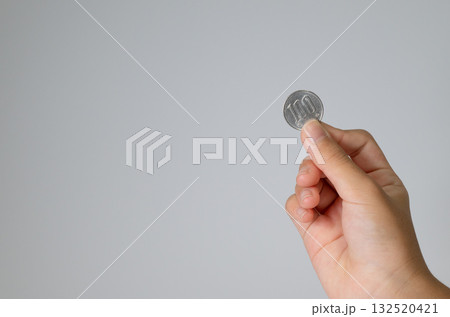 100円玉を差し出す手 132520421
