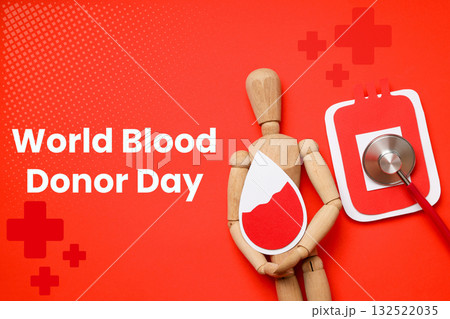 Wooden figure holding a blood drop symbol on a bright background 132522035