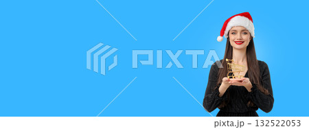 Woman in black dress smiles while holding small shopping cart Woman in black dress smiles while holding small shopping cart 132522053