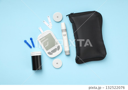 Glucose meter and diabetes supplies arranged on blue background Glucose meter and diabetes supplies arranged on blue background 132522076