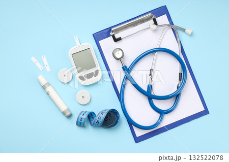 Stethoscope, blood glucose meter, and measuring tape arranged Stethoscope, blood glucose meter, and measuring tape arranged 132522078
