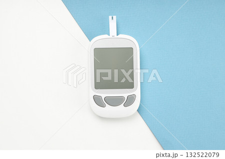 Blank screen blood glucose meter on blue-white surface Blank screen blood glucose meter on blue-white surface 132522079