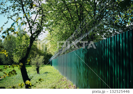 Green Fence With Barbed Wire 132525446