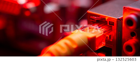 Fiber Optic cables connected to an optic ports and Network cables connected to ethernet ports. 132525603