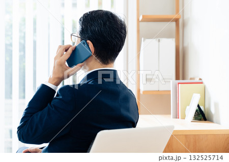 スマホで通話する中高年のビジネスマン 132525714