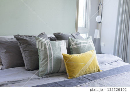 Stylish Bedroom in blue and white tone pillows setting. Cozy bedroom with art wall. Stylish Bedroom in blue and white tone pillows setting. Cozy bedroom with art wall. 132526192
