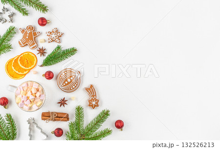 Christmas composition with gingerbread cookies, fir branches, orange slices, cup of cocoa with marshmallows, cinnamon sticks and ornaments on white background, festive flat lay with copy space Christmas composition with gingerbread cookies, fir branches, orange slices, cup of cocoa with marshmallows, cinnamon sticks and ornaments on white background, festive flat lay with copy space 132526213