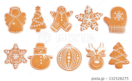 Collection of festive gingerbread cookies in various Christmas shapes with white icing on white background, top view symbolizing holiday baking and winter traditions. 132526275