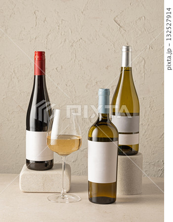 various wine bottles and glass of white wine 132527914