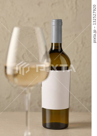 wine bottle and defocused glass of white wine wine bottle and defocused glass of white wine 132527920