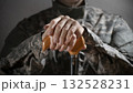 Soldier in camouflage uniform holding a cane, symbolizing veteran support and resilience 132528231