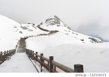 Lijiang, China - April 10, 2024 : Crowd of tourist sightseeing on Jade dragon snow mountain in Lijiang, China on April 10, 2024. Lijiang, China - April 10, 2024 : Crowd of tourist sightseeing on Jade dragon snow mountain in Lijiang, China on April 10, 2024. 132528315