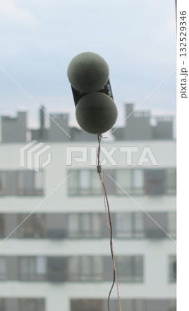 Vertical video Close up automatic window cleaning robot operating on residential window. Simplicity and convenience of window cleaning. Vertical video Close up automatic window cleaning robot operating on residential window. Simplicity and convenience of window cleaning. 132529346