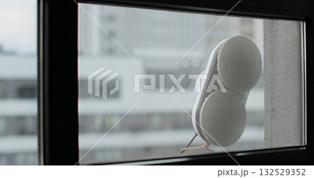 Robot window cleaner washes a window. Cleaning process with modern household appliances. Simplicity and convenience of window cleaning. 132529352
