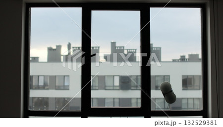 Washing of panoramic windows. Window cleaning robot. The assistant window cleaner robot moves on soft pads on the glass. Polishing of the glass surface. 132529381