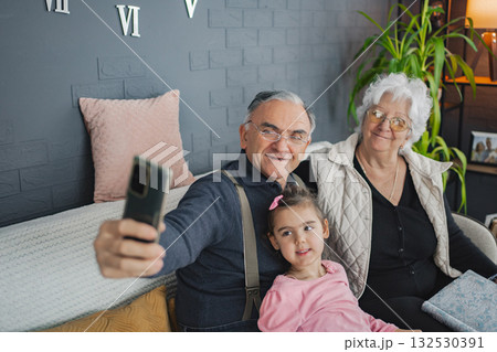 Grandparents and granddaughter share a joyful moment Grandparents and granddaughter share a joyful moment 132530391