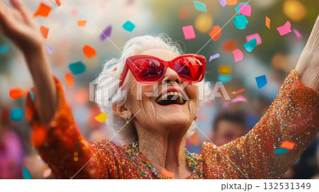 Joyful Elderly Woman Celebrating with Confetti and Laughter Joyful Elderly Woman Celebrating with Confetti and Laughter 132531349